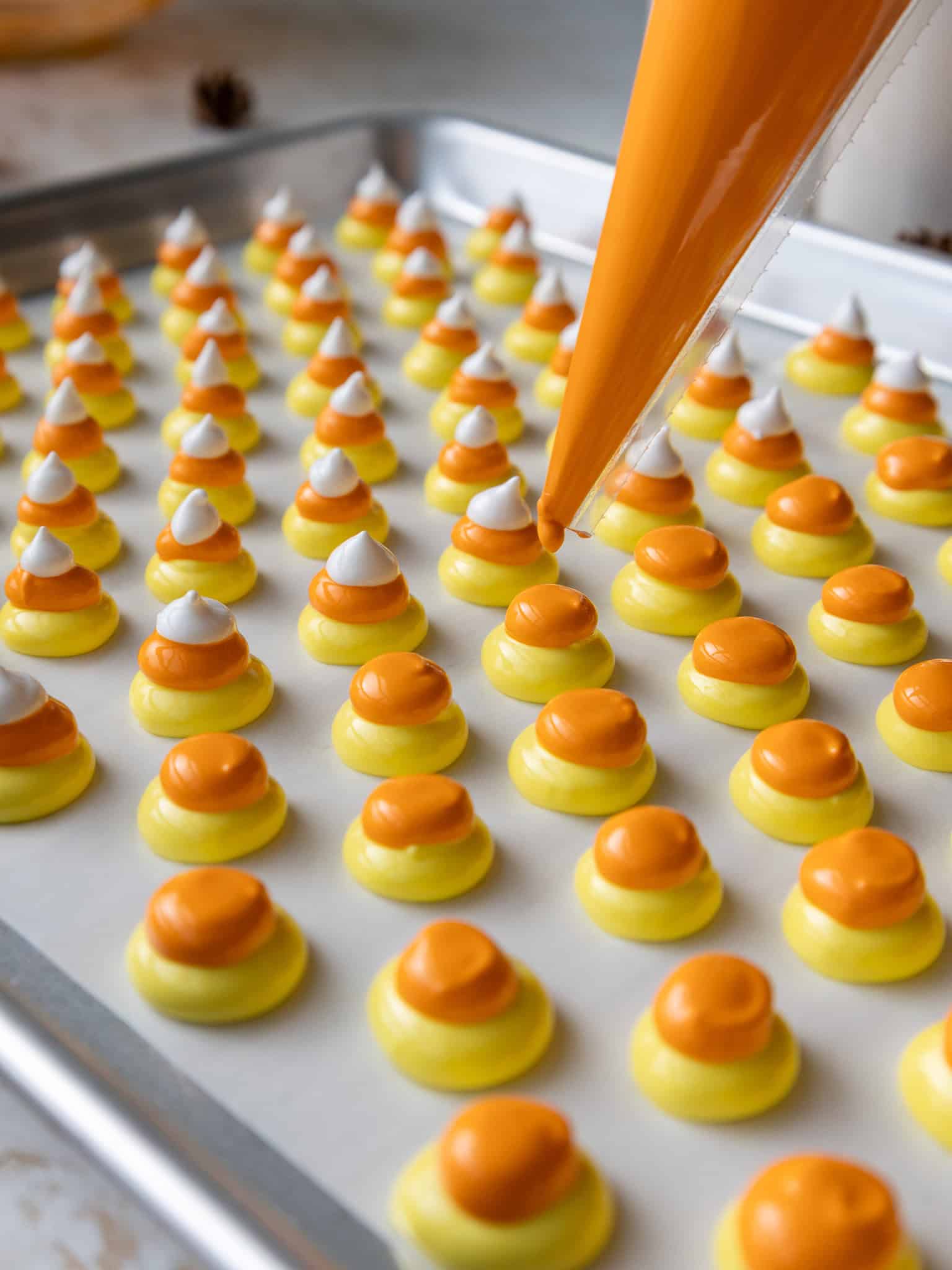 image of candy corn meringues being piped