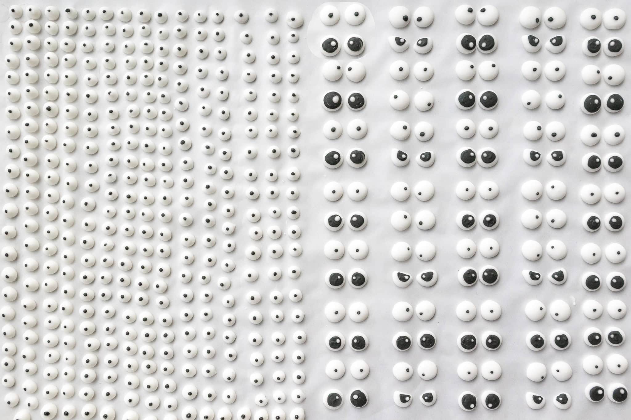 image of candy eyes that have been piped on parchment paper