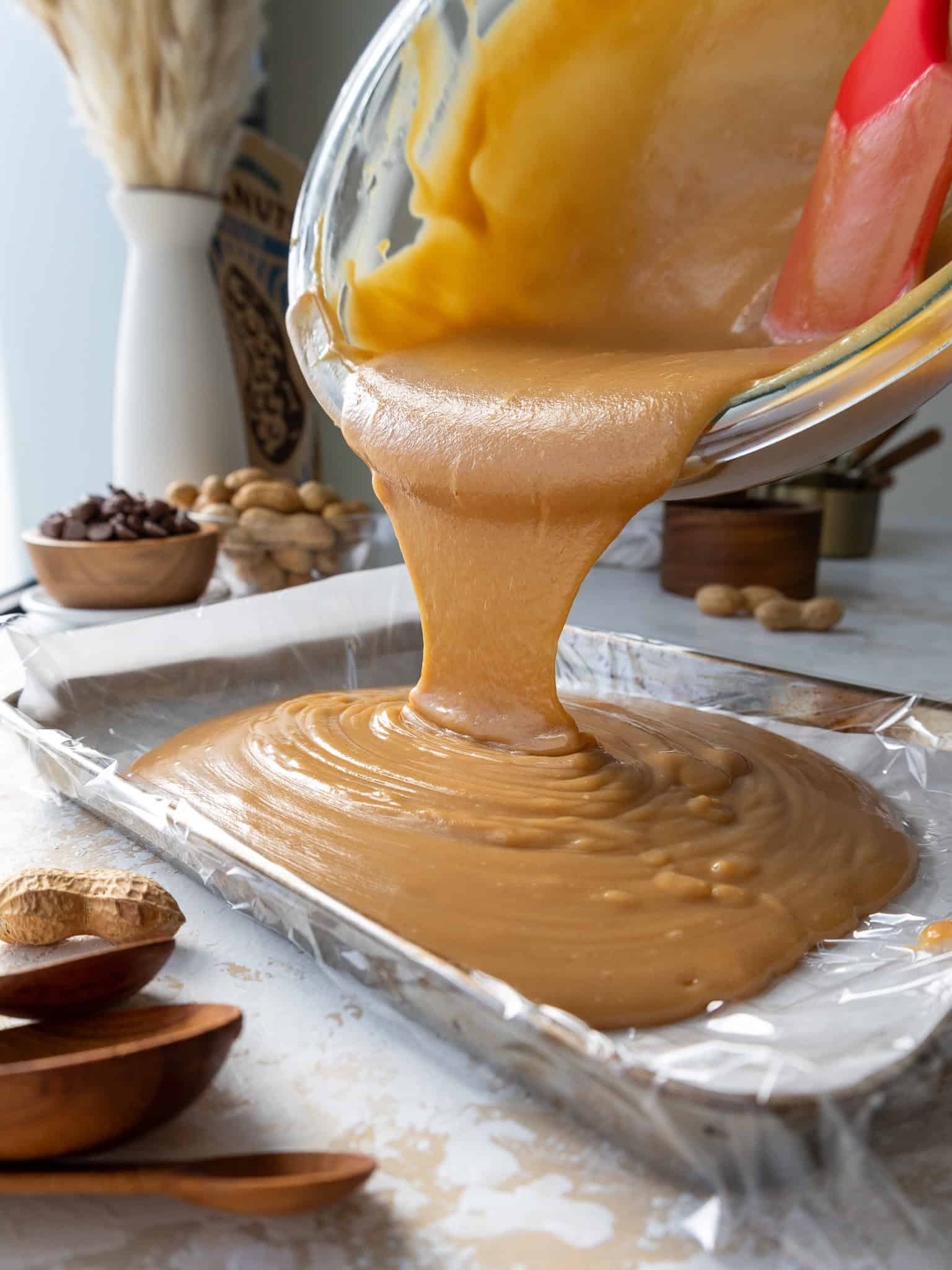 image of peanut butter ganache being poured into a shallow pan