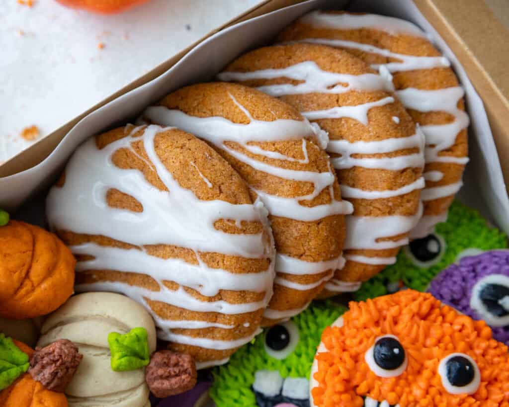 image of cream cheese drizzled pumpkin cheesecake cookies