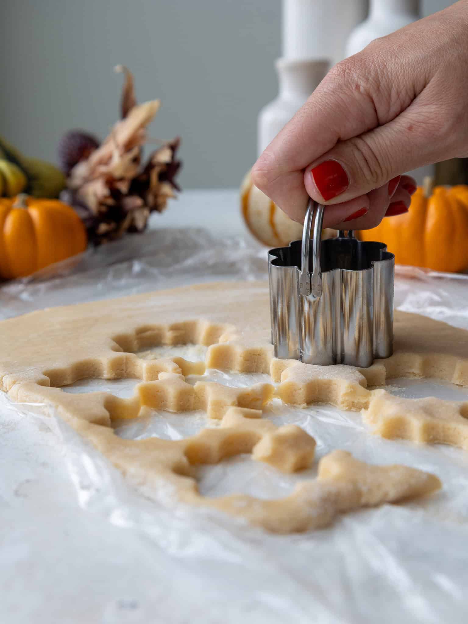 image of cookies being cut with a flower shaped cookie cutter to make turkey cookies