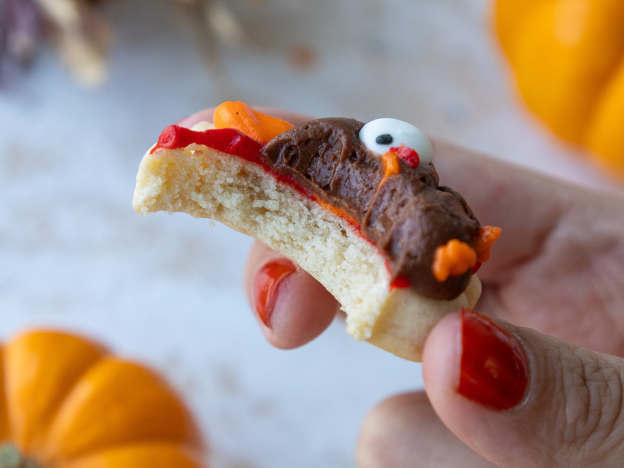 image of a buttercream turkey cookie that's been bitten into