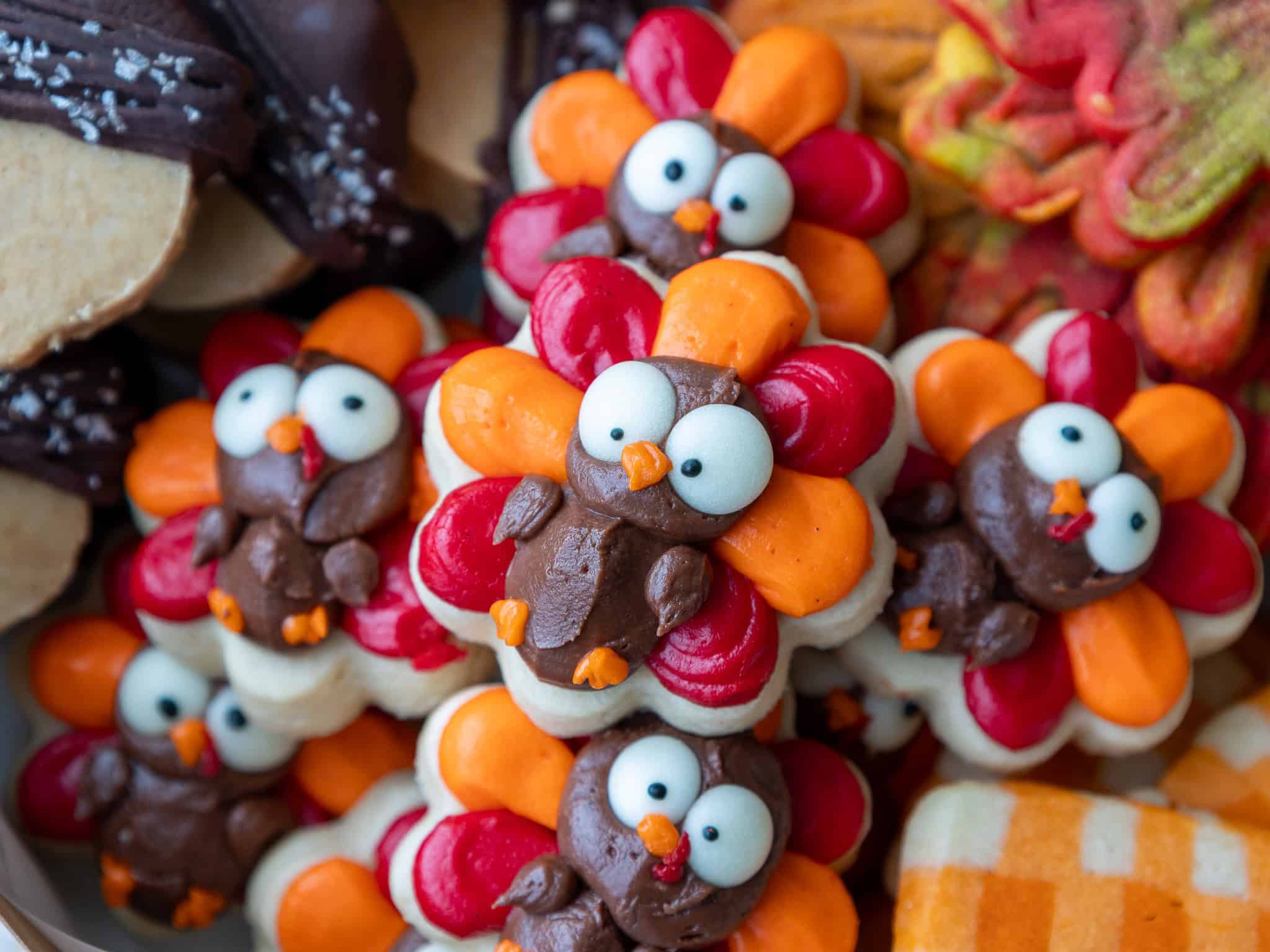 image of buttercream turkey cookies that have been stacked to put in a thanksgiving cookie box