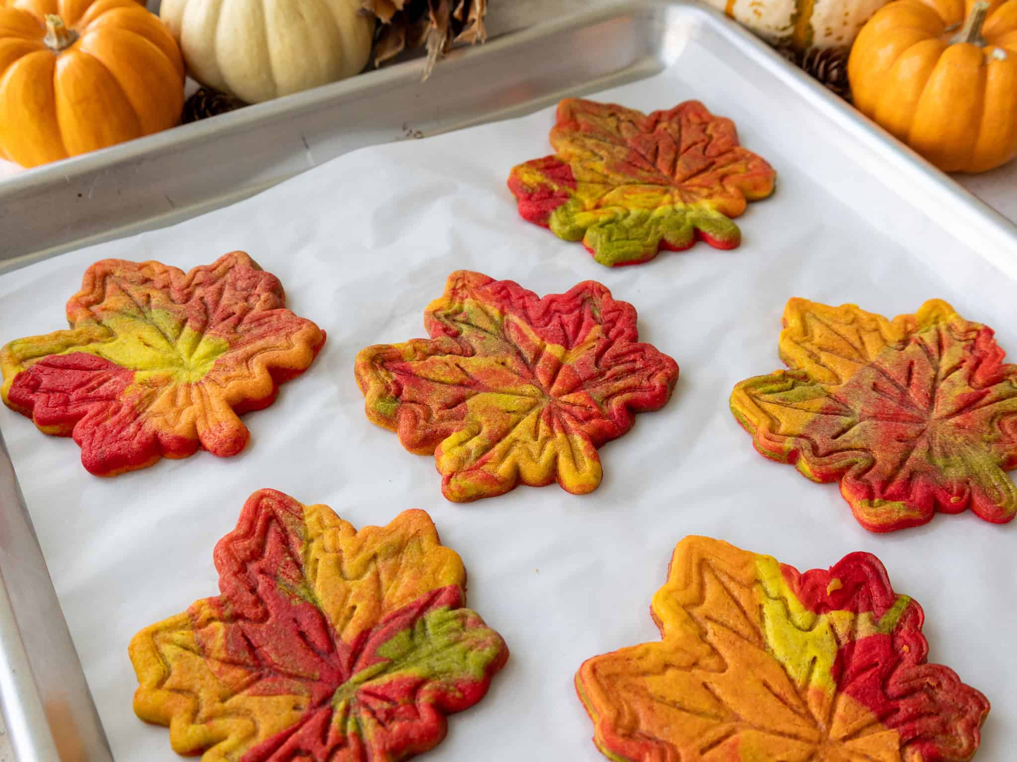 image of baked marbled maple leaf cookies cooling on a baking sheet