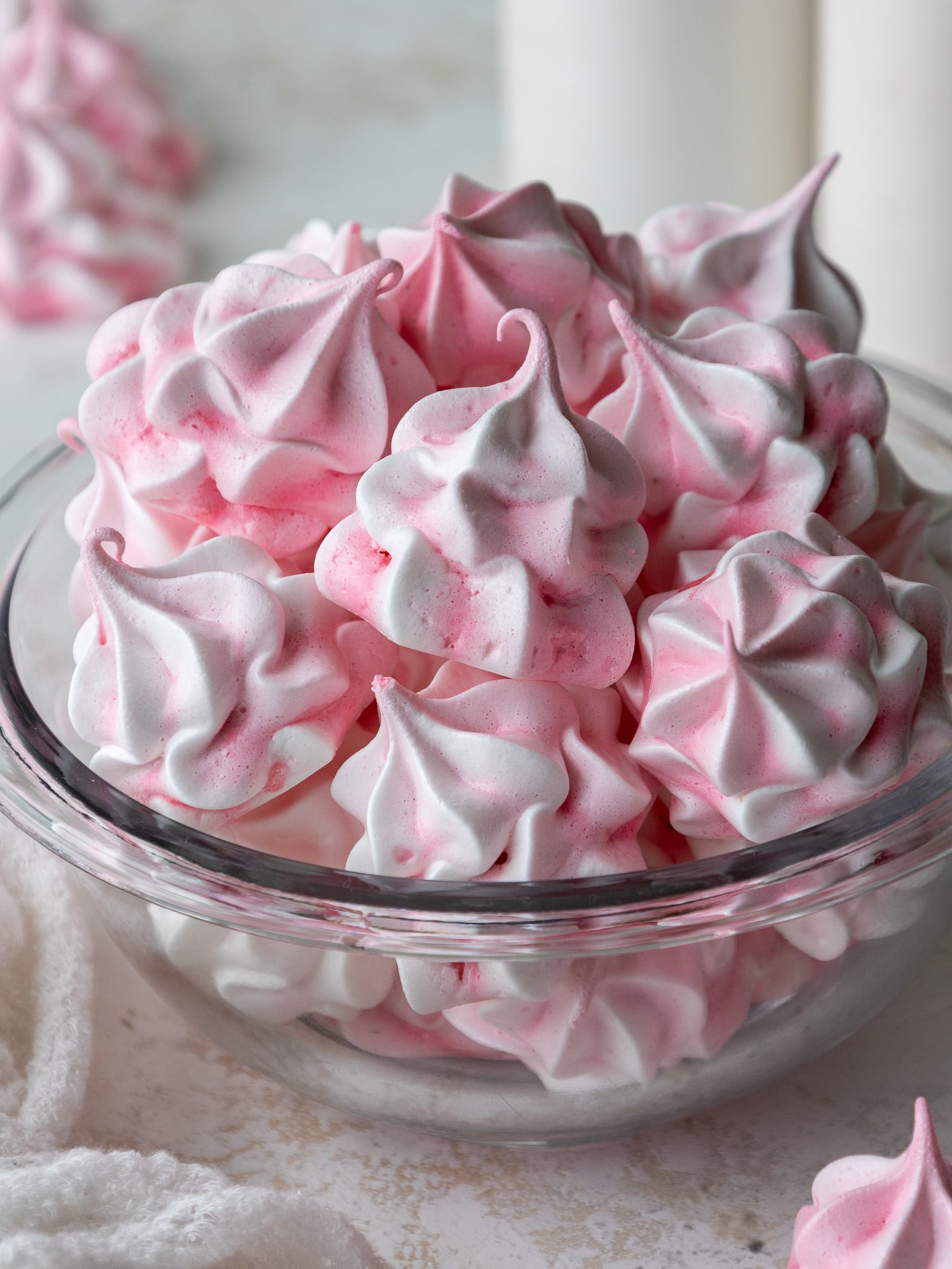 image of meringue cookies that have been colored pink and piped with a large french piping tip